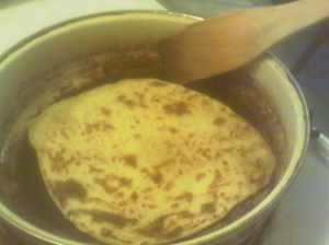 Turn with a small spatula or flat stick and finish rolling the next one